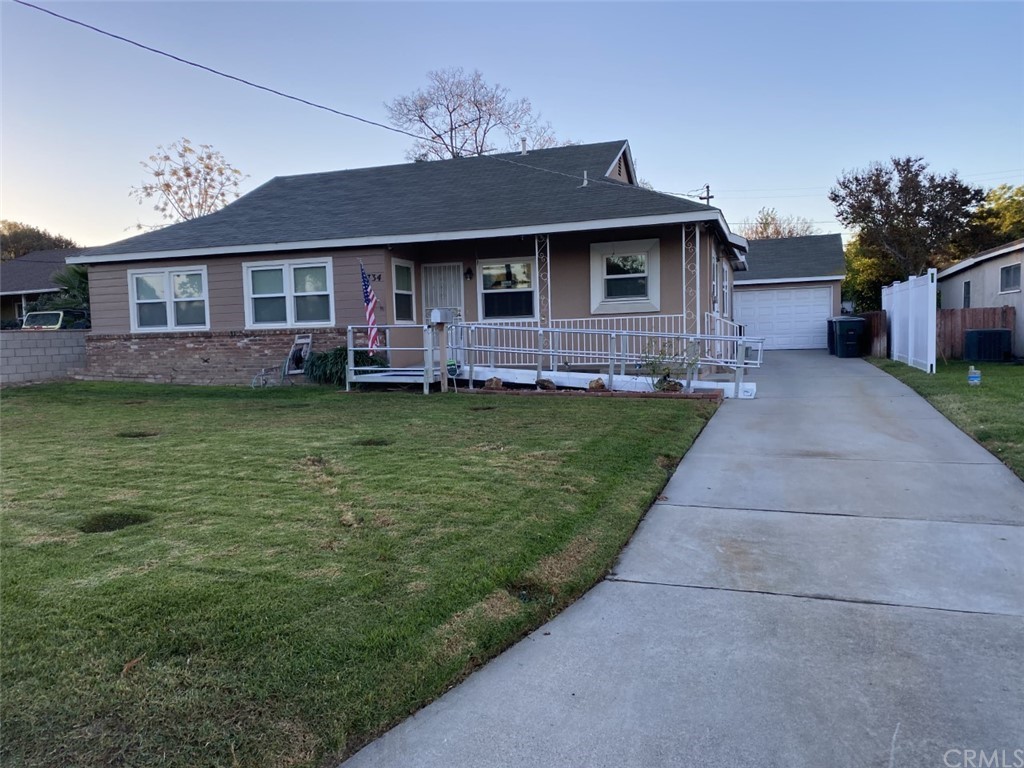 4734 Sierra Street Riverside, CA 92504 - Photo 1 of 1 a front view of a house with a garden