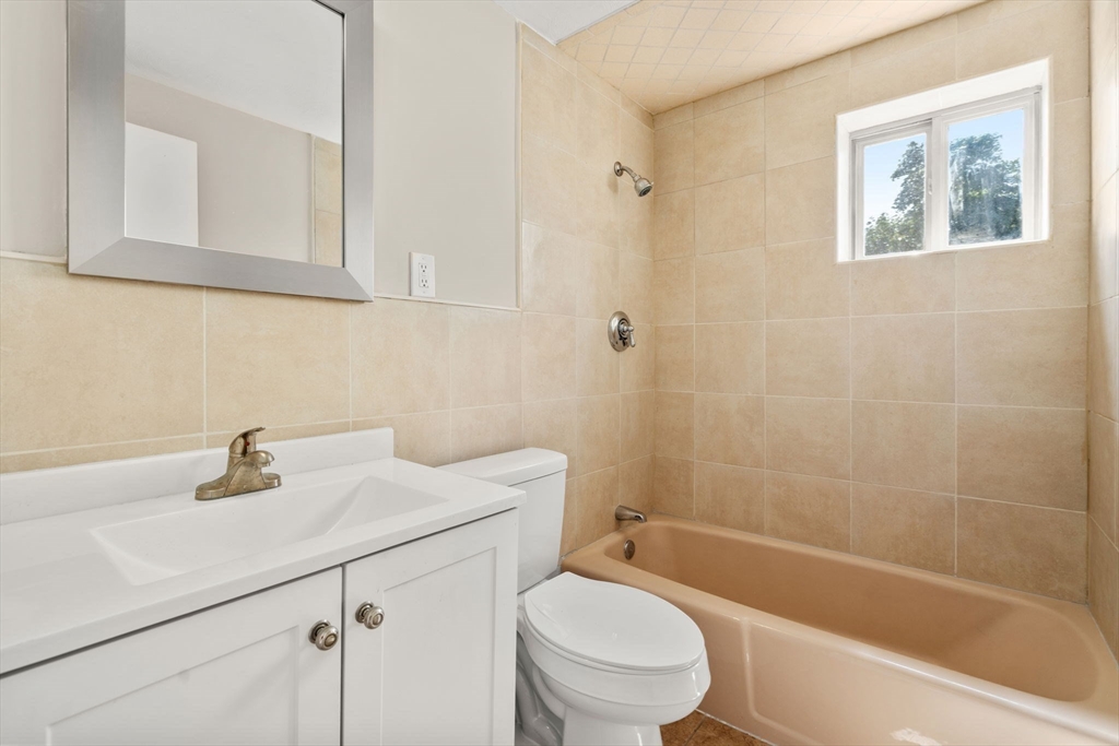 15 Staples Avenue, Unit 41 Everett, MA 02149 - Photo 9 of 9 a bathroom with a sink a toilet and shower