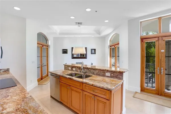 a spacious bathroom with a granite countertop sink and a mirror