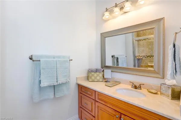 a bathroom with a sink vanity and a mirror