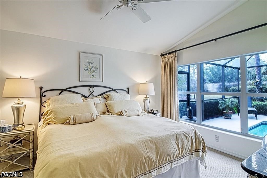10072 Oakhurst Way Fort Myers, FL 33913 - Photo 13 of 26 a bedroom with a large bed and a balcony view