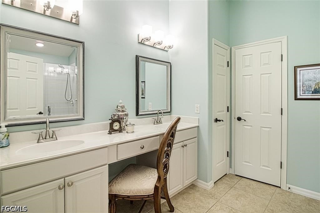 10072 Oakhurst Way Fort Myers, FL 33913 - Photo 15 of 26 a bathroom with a sink vanity and a mirror