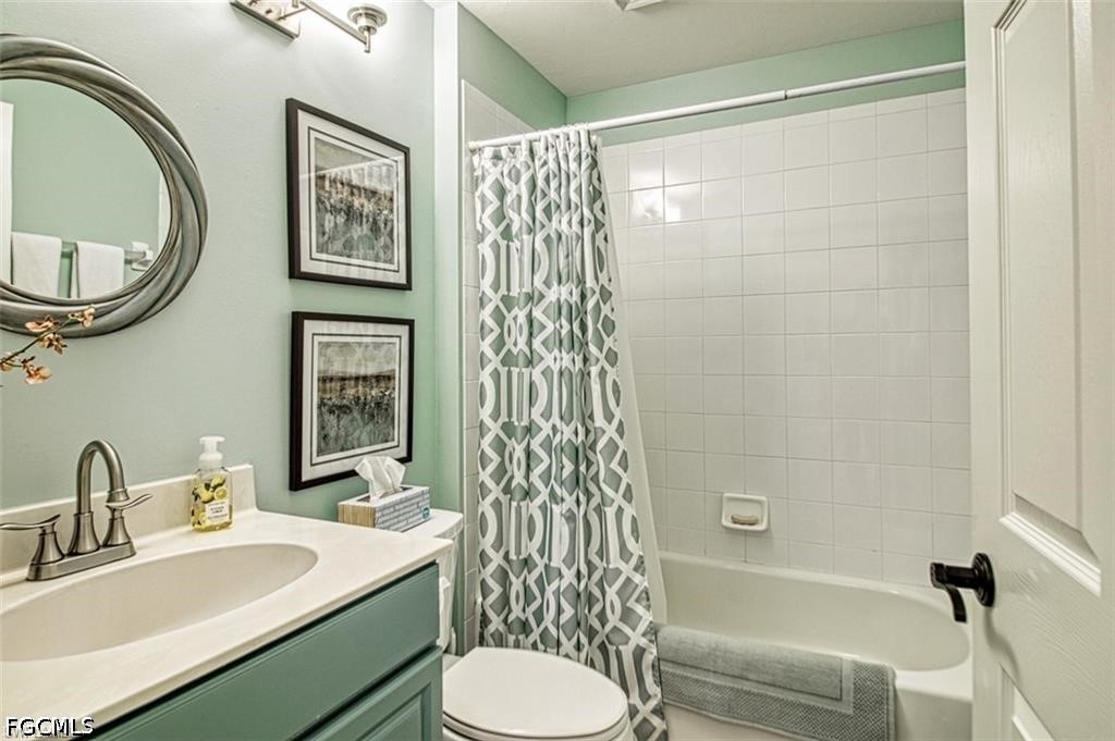 10072 Oakhurst Way Fort Myers, FL 33913 - Photo 18 of 26 a bathroom with a sink a toilet and a mirror
