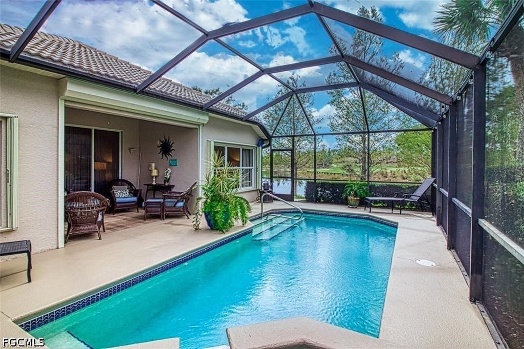10072 Oakhurst Way Fort Myers, FL 33913 - Photo 22 of 26 a swimming pool with outdoor seating