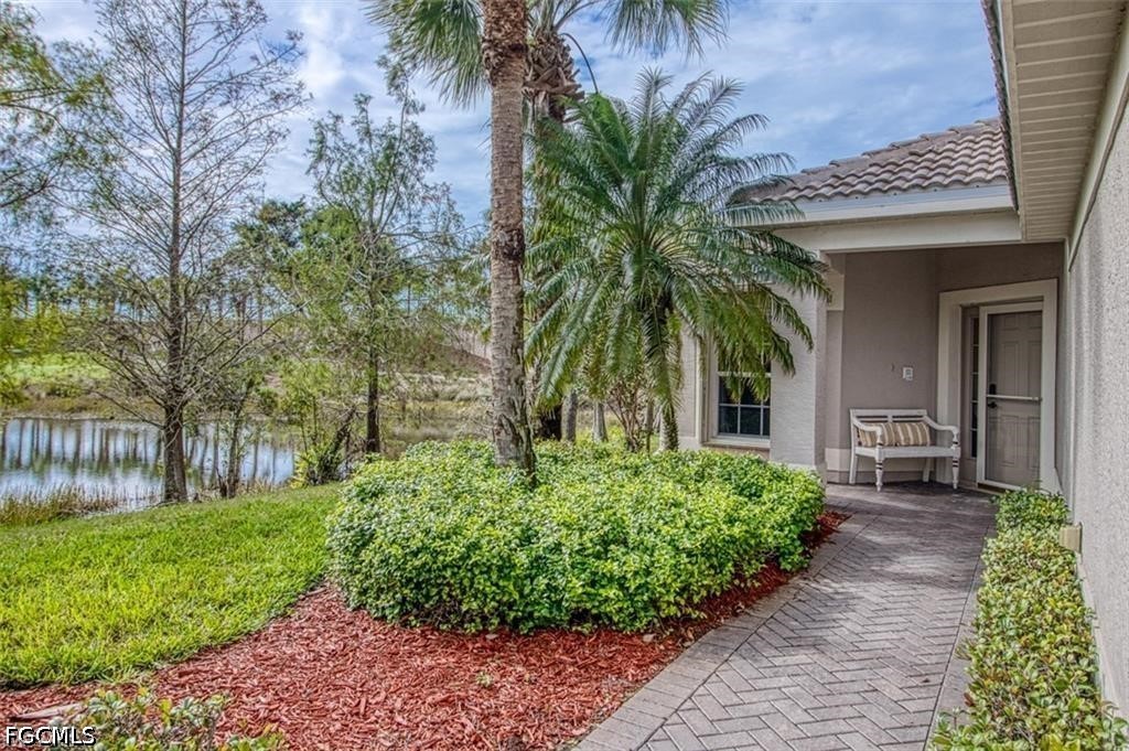 10072 Oakhurst Way Fort Myers, FL 33913 - Photo 4 of 26 a front view of house with a garden