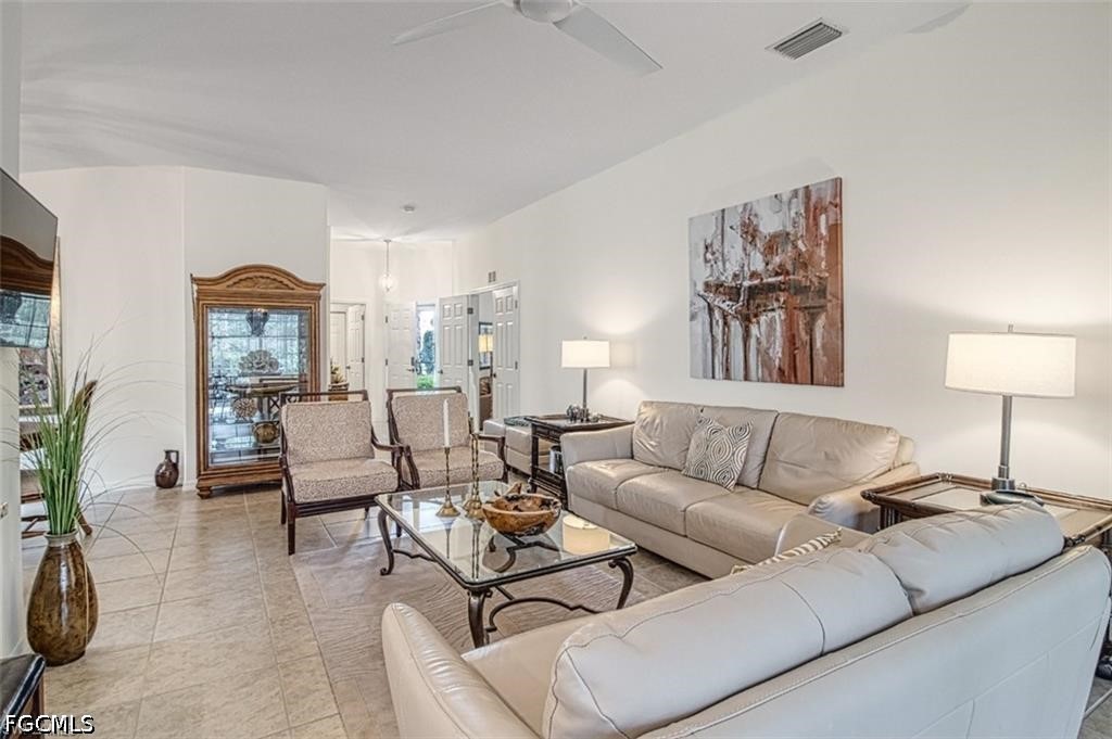10072 Oakhurst Way Fort Myers, FL 33913 - Photo 6 of 26 a living room with furniture and a lamp