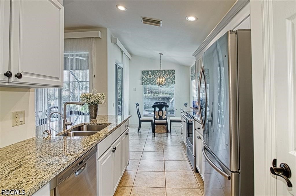 10072 Oakhurst Way Fort Myers, FL 33913 - Photo 7 of 26 a very nice looking kitchen with granite countertop a large counter top space and stainless steel appliances