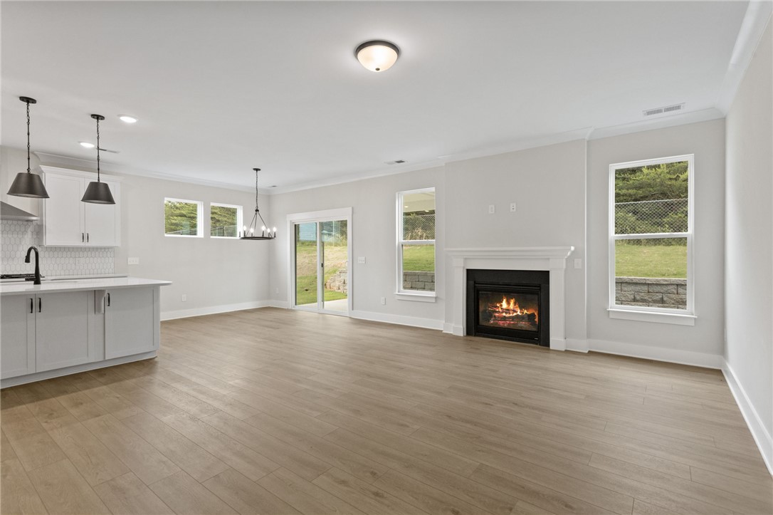 313 Old Shirley Road Central, SC 29630 - Photo 10 of 30 This bright, open-concept living space features warm flooring and a cozy fireplace.