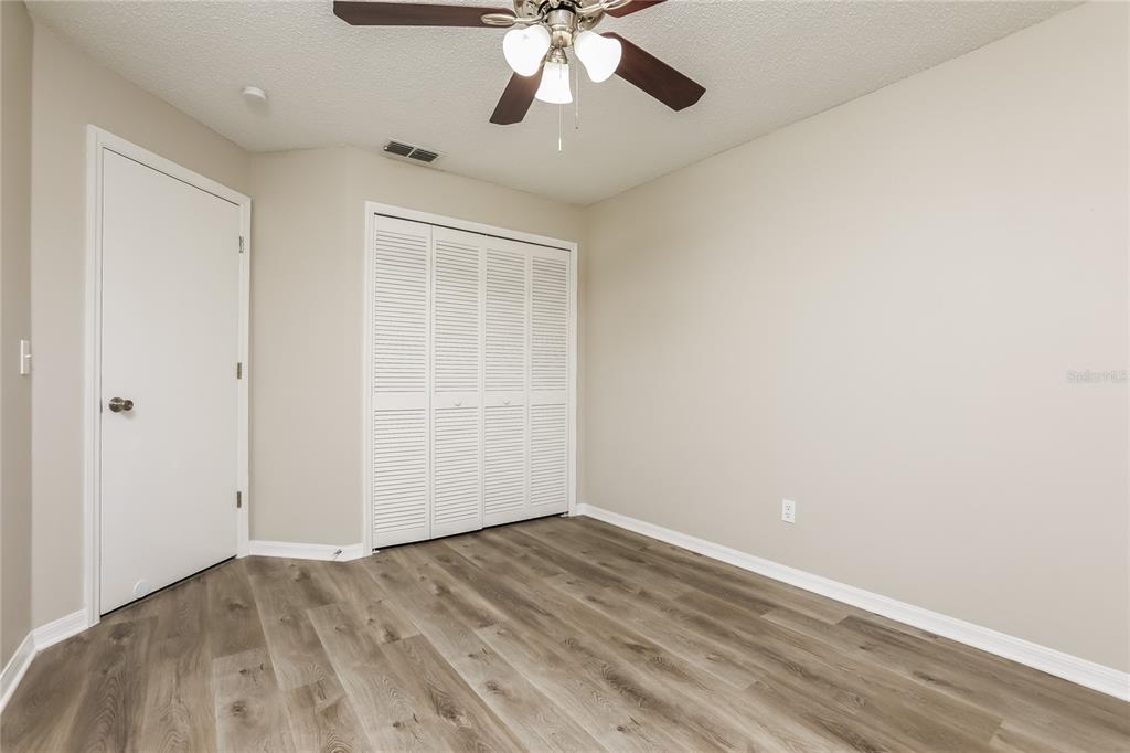 3007 East Beaumont Lane Eustis, FL 32726 - Photo 11 of 16 wooden floor in an empty room with a window