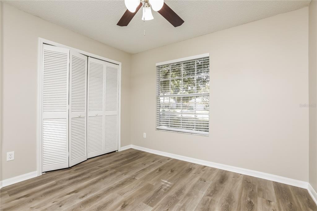 3007 East Beaumont Lane Eustis, FL 32726 - Photo 12 of 16 a view of an empty room with a window and wooden floor