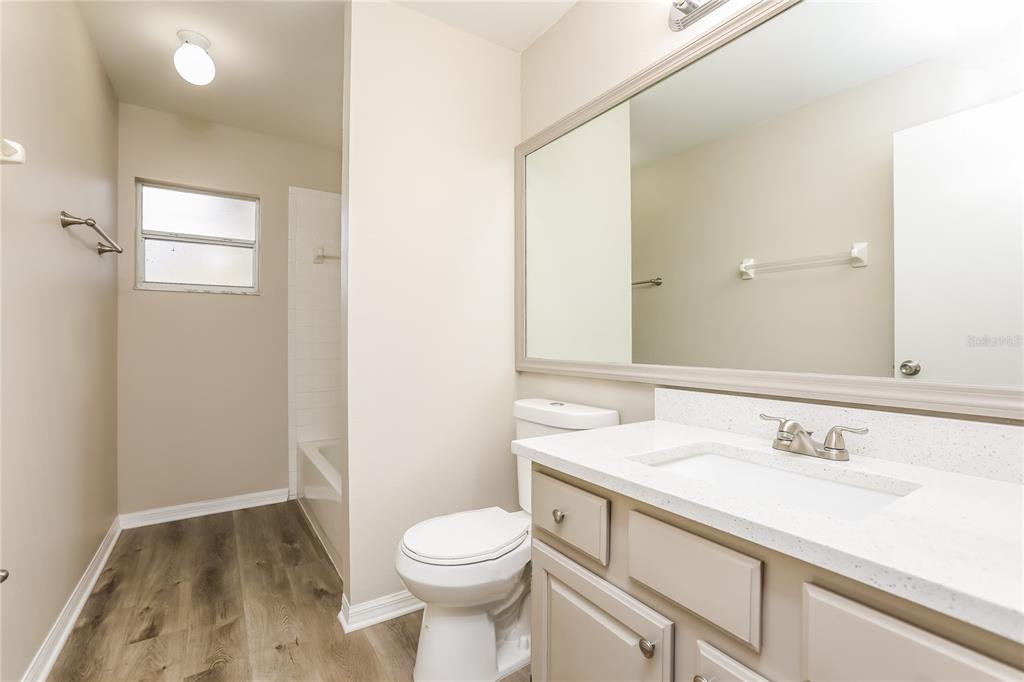 3007 East Beaumont Lane Eustis, FL 32726 - Photo 13 of 16 a bathroom with a sink a toilet and vanity