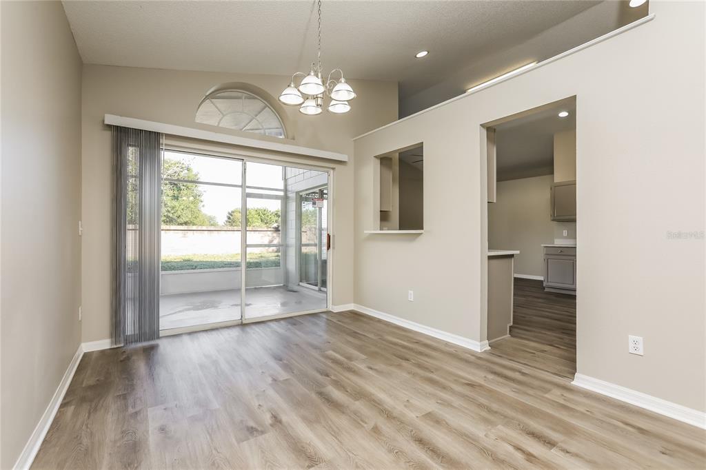 3007 East Beaumont Lane Eustis, FL 32726 - Photo 4 of 16 wooden floor in an empty room with a window