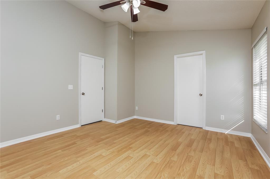 3007 East Beaumont Lane Eustis, FL 32726 - Photo 8 of 16 wooden floor in an empty room with a window