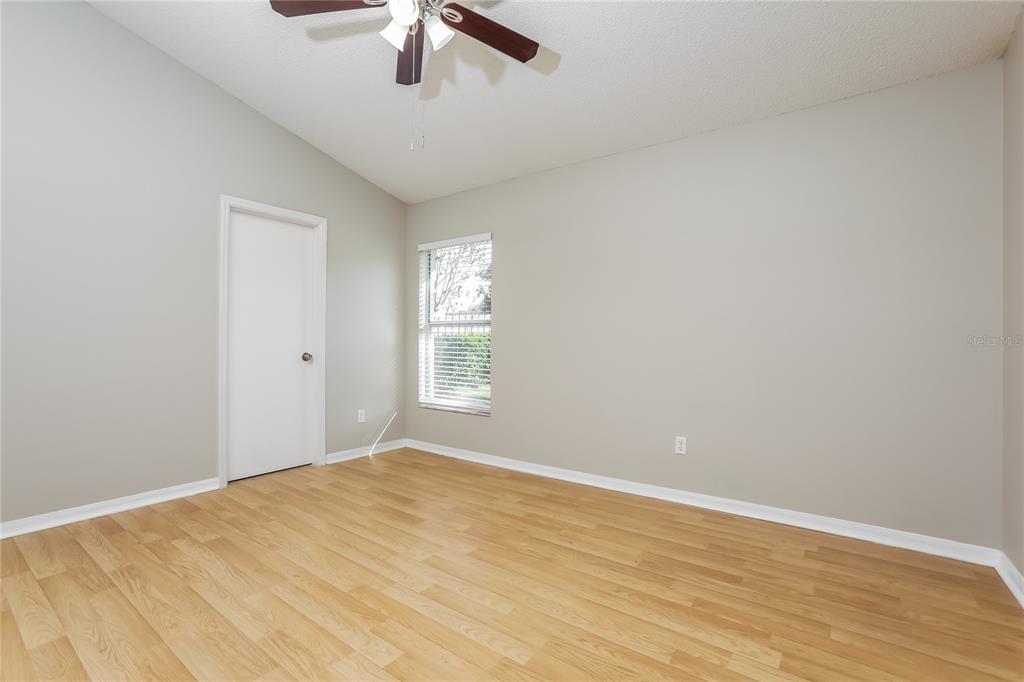 3007 East Beaumont Lane Eustis, FL 32726 - Photo 9 of 16 wooden floor in an empty room with a window