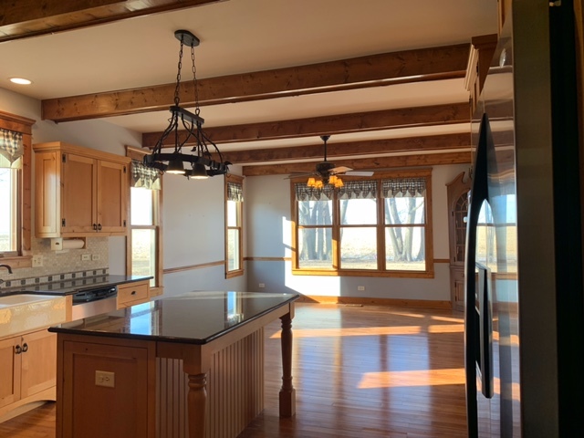 17885 Harter Road Maple Park, IL 60151 - Photo 5 of 16 a view of a kitchen with a sink and wooden floor