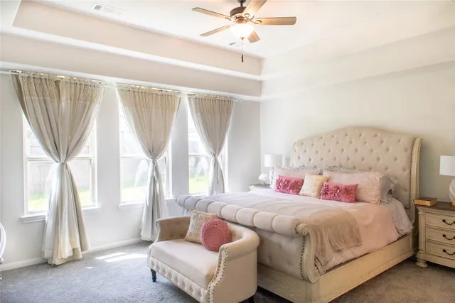a bedroom with a bed and a chandelier