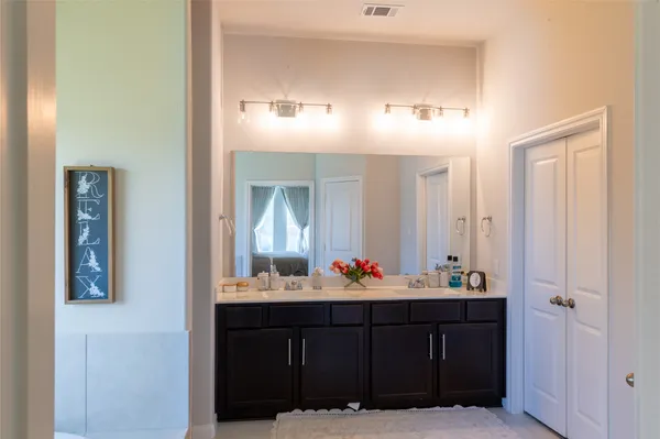 a bathroom with a sink vanity and mirror