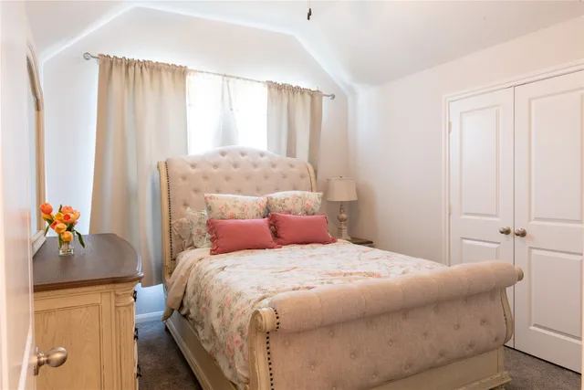 a bedroom with a large bed and a window