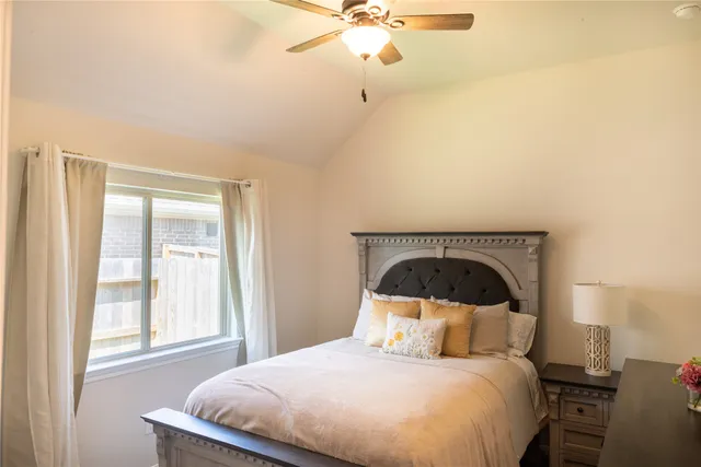 a bedroom with a large bed and a window