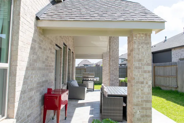 a front view of a house with outdoor seating