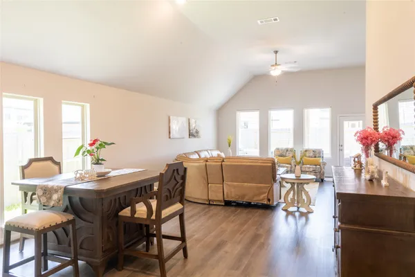 a dining room with furniture and wooden floor