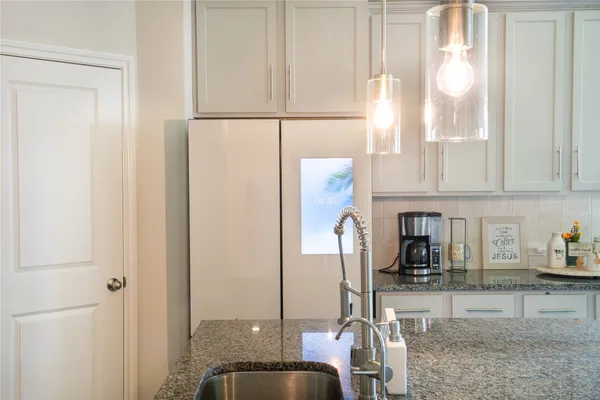 a kitchen with a refrigerator and cabinets