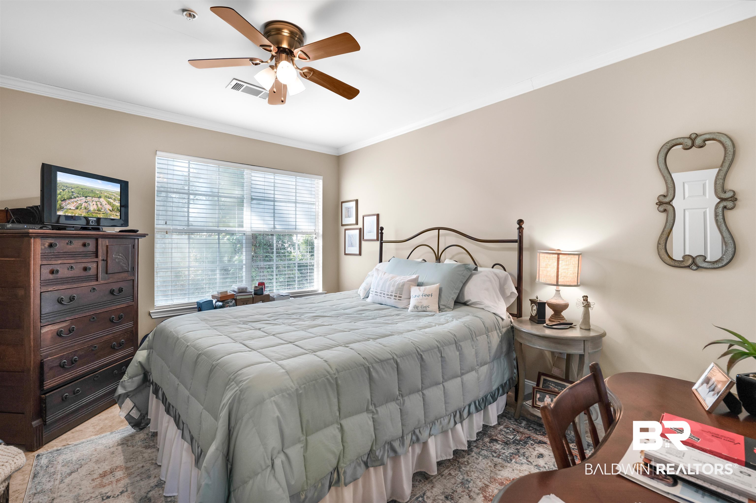 1517 Regency Road, Unit 68 Gulf Shores, AL 36542 - Photo 22 of 43 Bedroom with ceiling fan and crown molding