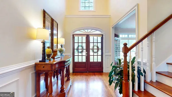 a view of front door and porch with wooden floor