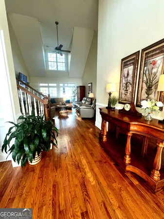 a living room with fireplace furniture and a chandelier
