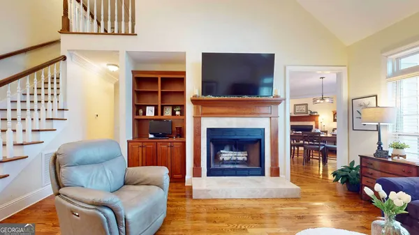 a living room with furniture a flat screen tv and a fireplace