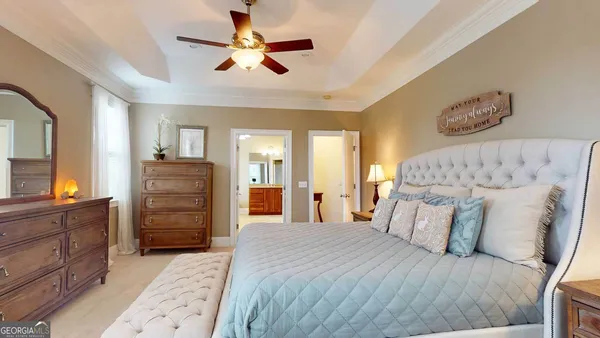 a spacious bedroom with a bed and a chandelier