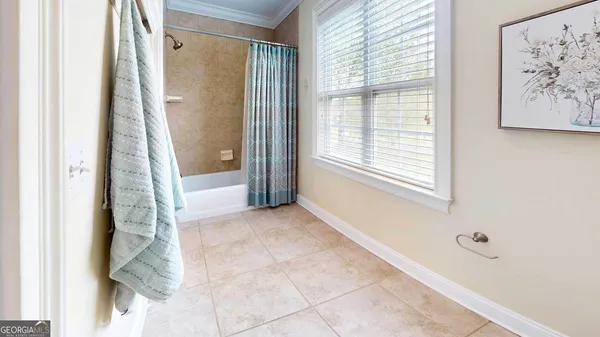 a spacious bathroom with a granite countertop sink and a mirror