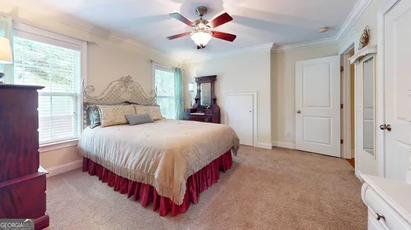 a bedroom with a large bed and a chandelier