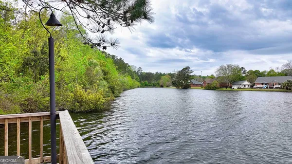 a wooden bench sitting on top of a lake