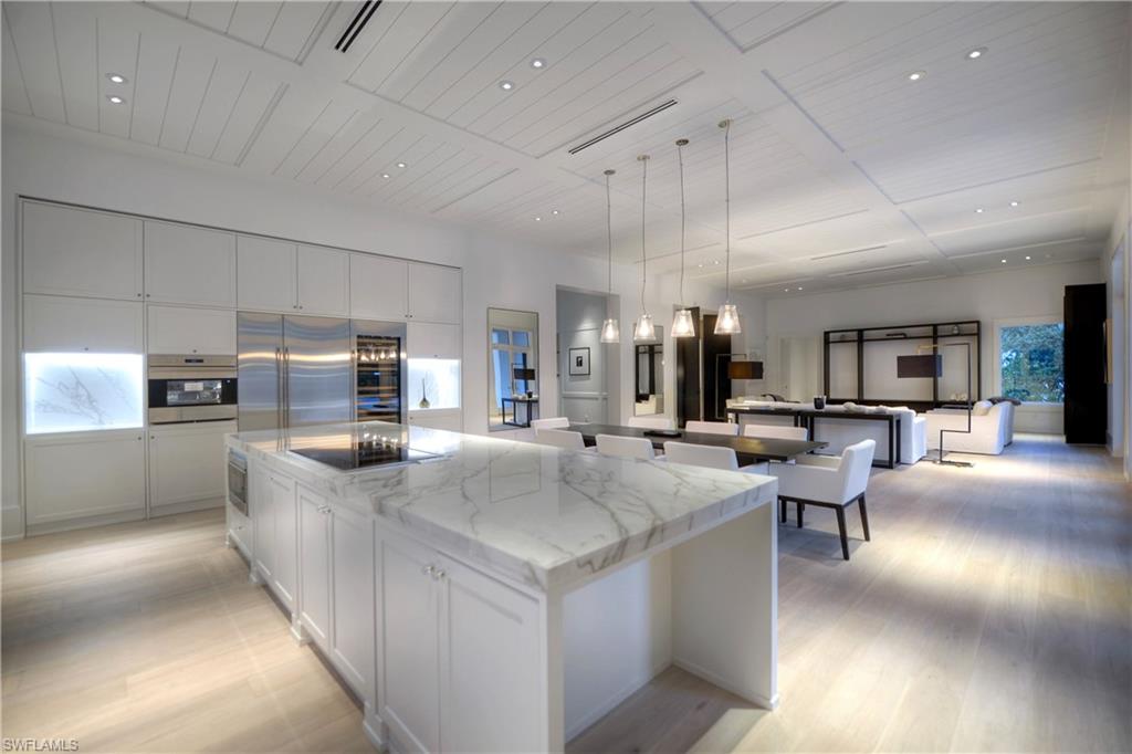 1355 Nautilus Road Naples, FL 34102 - Photo 17 of 24 a large kitchen with kitchen island a stove a sink a table and chairs