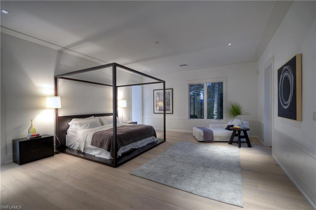 1355 Nautilus Road Naples, FL 34102 - Photo 22 of 24 a spacious bedroom with a bed and a couch