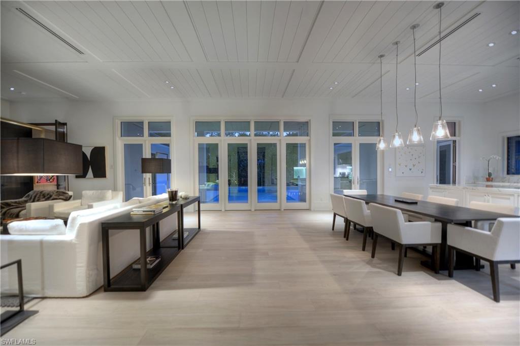 1355 Nautilus Road Naples, FL 34102 - Photo 8 of 24 a large white kitchen with a table and chairs