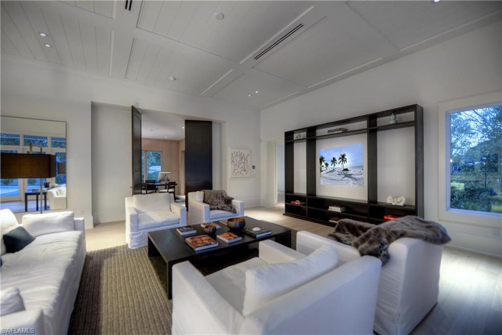 1355 Nautilus Road Naples, FL 34102 - Photo 10 of 24 a living room with furniture and a flat screen tv