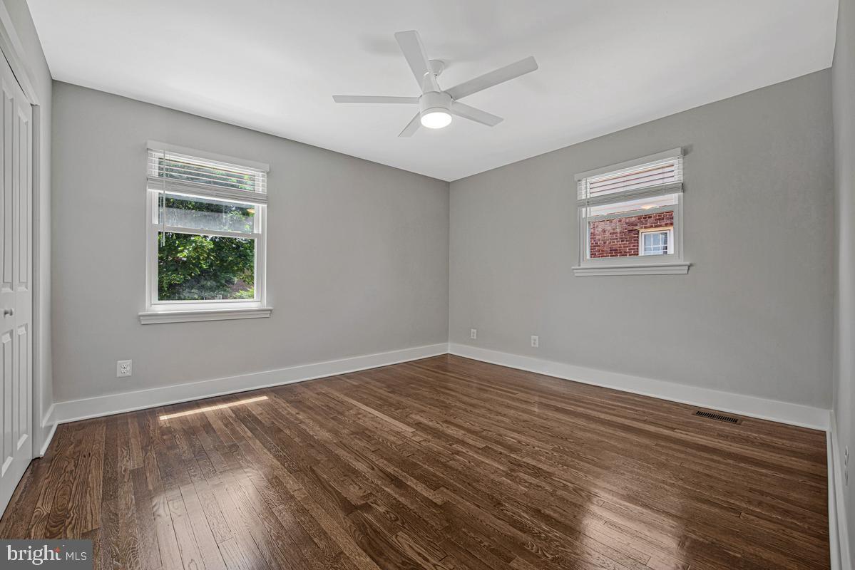 2105 Queens Chapel Road Mount Rainier, MD 20712 - Photo 11 of 33 a view of an empty room with wooden floor and a window