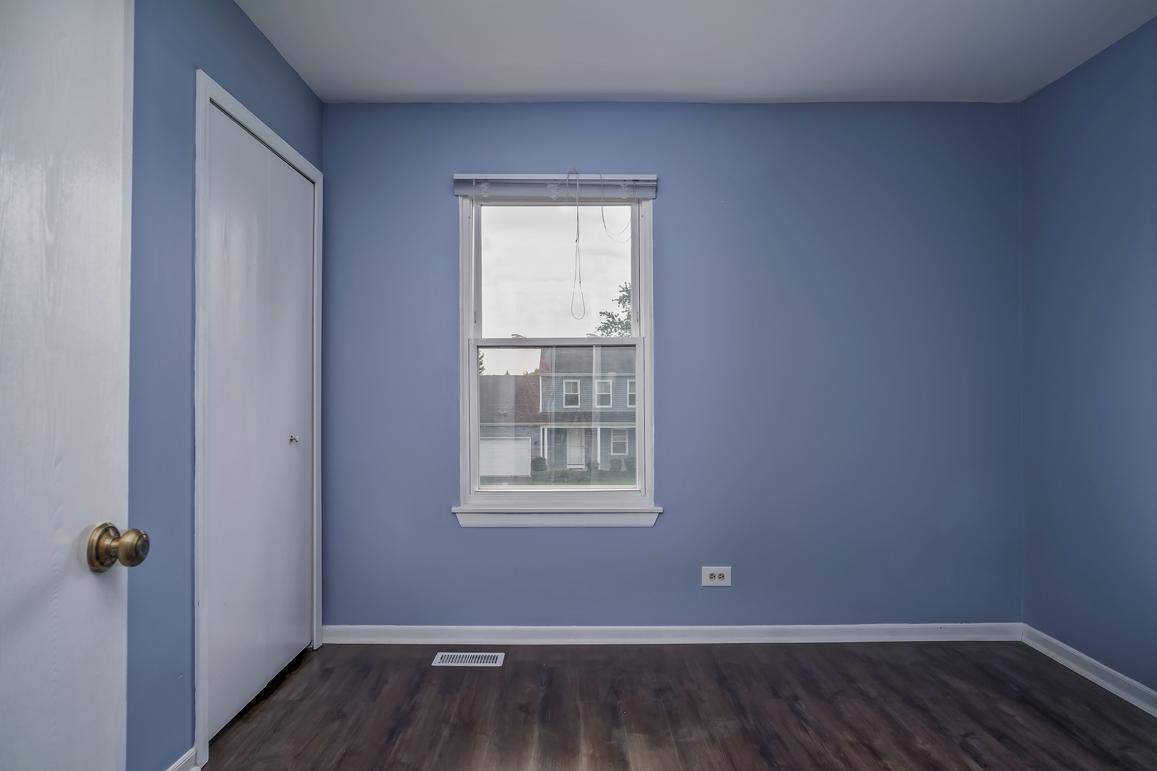 2860 Bridgeport Lane Aurora, IL 60504 - Photo 13 of 19 a view of an empty room with wooden floor and a window