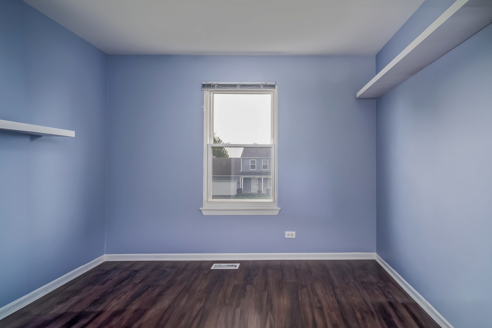 2860 Bridgeport Lane Aurora, IL 60504 - Photo 14 of 19 a view of an empty room with wooden floor and a window