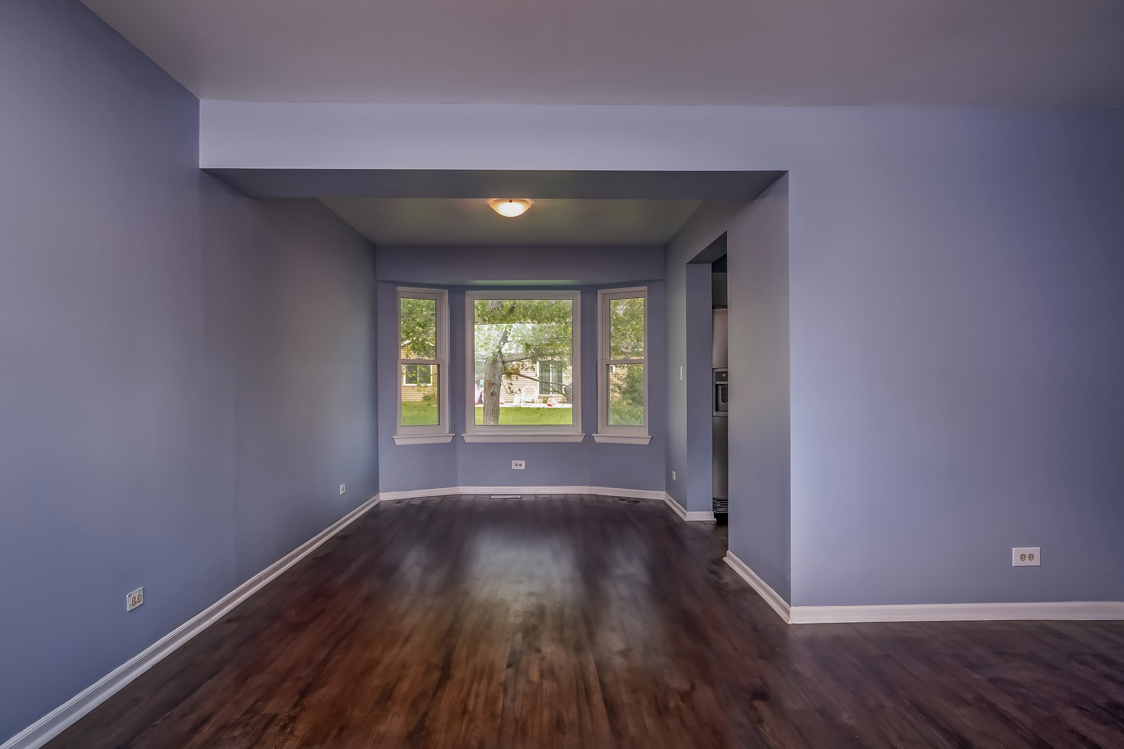 2860 Bridgeport Lane Aurora, IL 60504 - Photo 3 of 19 an empty room with wooden floor and windows
