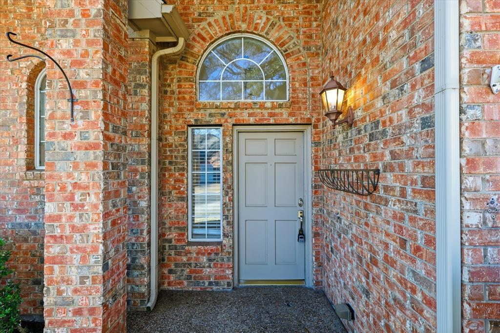 5023 Falcon Hollow Road McKinney, TX 75072 - Photo 4 of 25 Doorway to property with brick siding