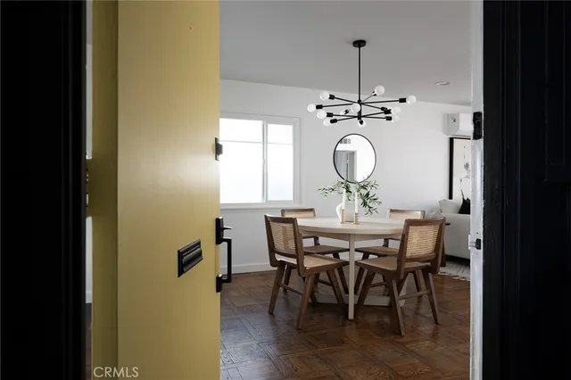 a view of a dining room with a table and chairs