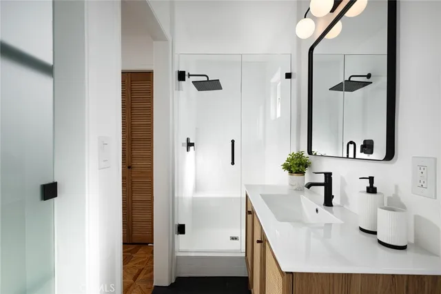 a bathroom with a granite countertop sink and a mirror