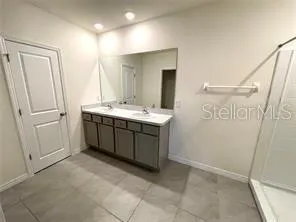 a spacious bathroom with a double vanity sink mirror and double