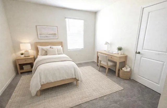 a bedroom with a bed and a large window