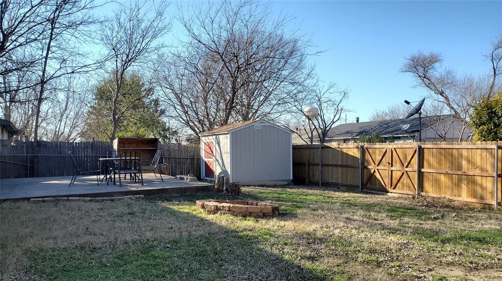 5724 Phelps Street The Colony, TX 75056 - Photo 8 of 11 a view of a backyard with a bench