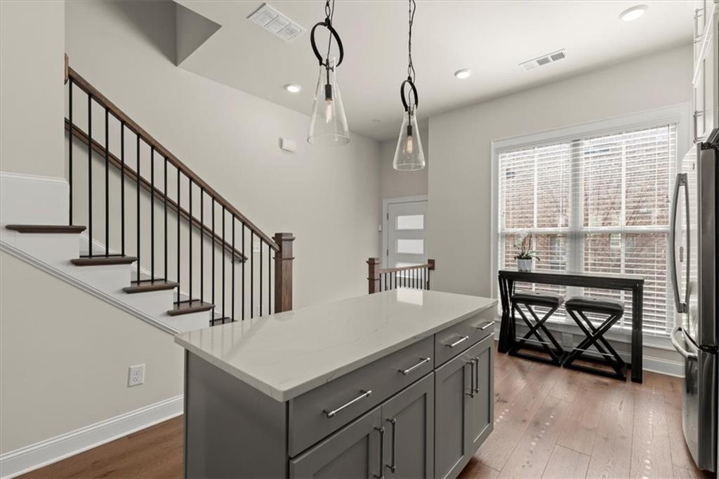 4217 Deming Circle Atlanta, GA 30342 - Photo 16 of 36 a kitchen with a stove a sink a dining table and chairs
