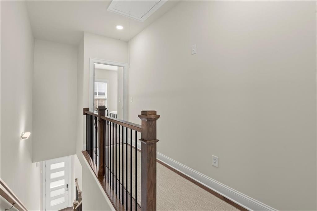 4217 Deming Circle Atlanta, GA 30342 - Photo 17 of 36 a view of a hallway with wooden floor and a bathroom